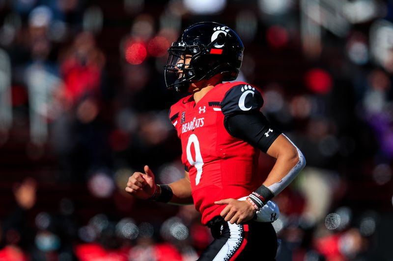 Oct 31, 2020; Cincinnati, Ohio, USA; Cincinnati Bearcats quarterback Desmond Ridder (9) reacts to the touchdown scored by running back Jerome Ford (24) in the game against the Memphis Tigers in the second half at Nippert Stadium. Mandatory Credit: Aaron Doster-USA TODAY Sports