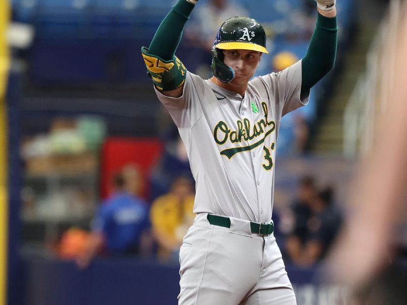 May 30, 2024; St. Petersburg, Florida, USA; Oakland Athletics outfielder JJ Bleday (33) celebrates to the dugout after he singles against the Tampa Bay Rays during the first inning  at Tropicana Field. Mandatory Credit: Kim Klement Neitzel-USA TODAY Sports