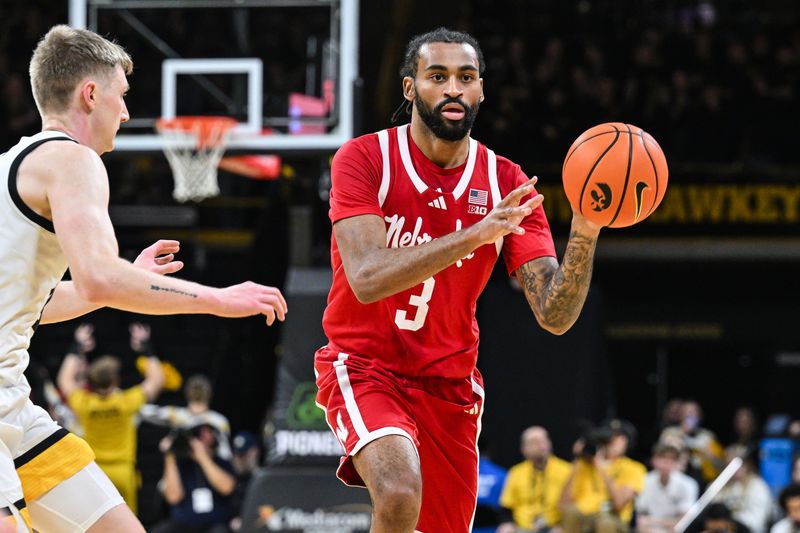 Jan 7, 2025; Iowa City, Iowa, USA; Nebraska Cornhuskers guard Brice Williams (3) looks to pass as Iowa Hawkeyes guard Josh Dix (4) defends during the first half at Carver-Hawkeye Arena. Mandatory Credit: Jeffrey Becker-Imagn Images