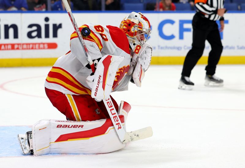 Nov 9, 2024; Buffalo, New York, USA;  Calgary Flames goaltender Dan Vladar (80) makes a save during the third period against the Buffalo Sabres at KeyBank Center. Mandatory Credit: Timothy T. Ludwig-Imagn Images