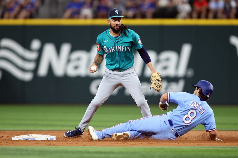 Jun 29, 2025; Arlington, Texas, USA; Seattle Mariners shortstop J.P. Crawford (3) cannot turn a double play against Texas Rangers first baseman Josh Smith (8) during the third inning at Globe Life Field. Mandatory Credit: Tim Heitman-Imagn Images