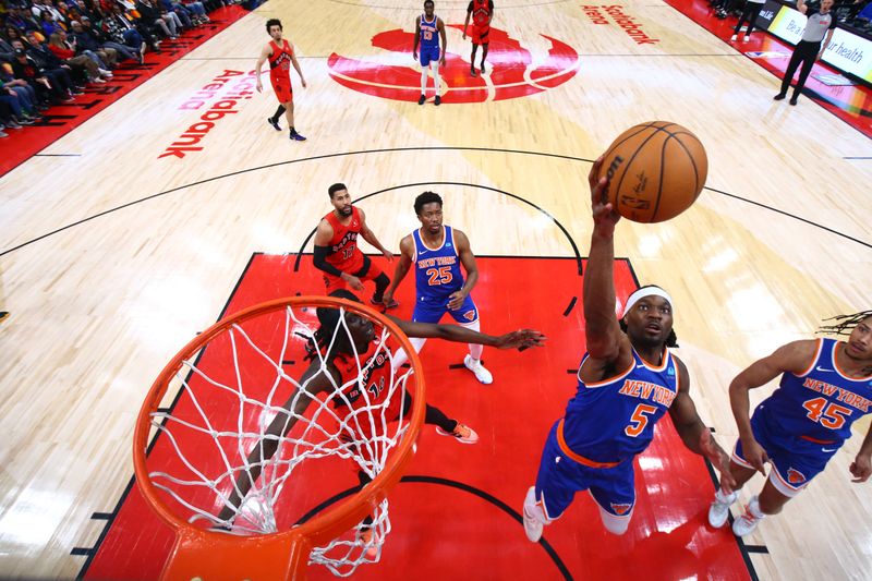 TORONTO, CANADA - MARCH 27: Precious Achiuwa #5 of the New York Knicks rebounds the ball during the game against the Toronto Raptors on March 27, 2024 at the Scotiabank Arena in Toronto, Ontario, Canada.  NOTE TO USER: User expressly acknowledges and agrees that, by downloading and or using this Photograph, user is consenting to the terms and conditions of the Getty Images License Agreement.  Mandatory Copyright Notice: Copyright 2024 NBAE (Photo by Vaughn Ridley/NBAE via Getty Images)