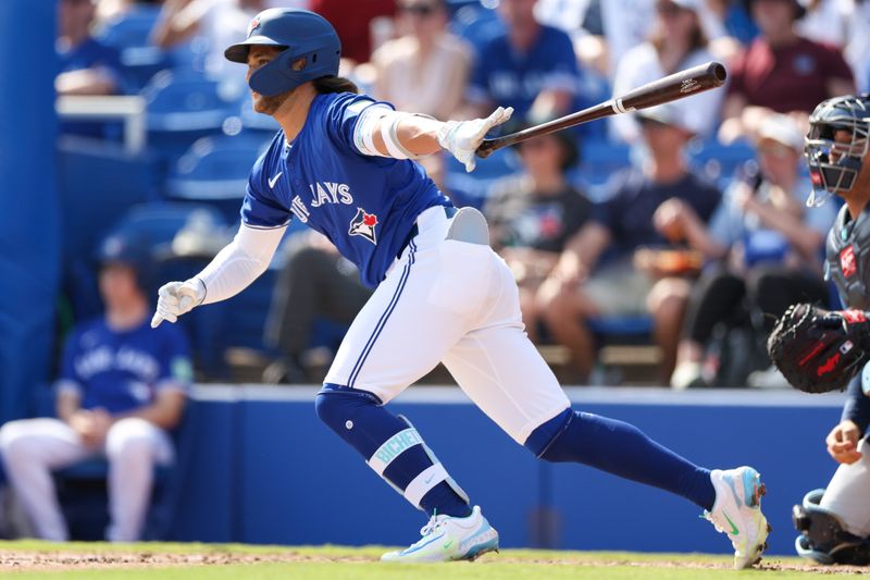 Feb 28, 2024; Dunedin, Florida, USA;  Toronto Blue Jays shortstop Bo Bichette (11) hits a base hit against the Tampa Bay Rays in the fifth inning at TD Ballpark. Mandatory Credit: Nathan Ray Seebeck-USA TODAY Sports