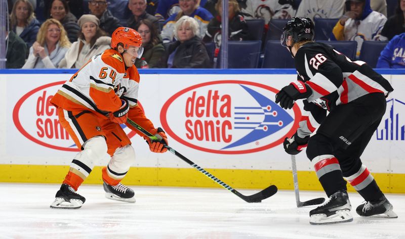 Jan 10, 2026; Buffalo, New York, USA;  Anaheim Ducks center Mikael Granlund (64) skatesn with the puck as Buffalo Sabres defenseman Rasmus Dahlin (26) defends during the first period at KeyBank Center. Mandatory Credit: Timothy T. Ludwig-Imagn Images