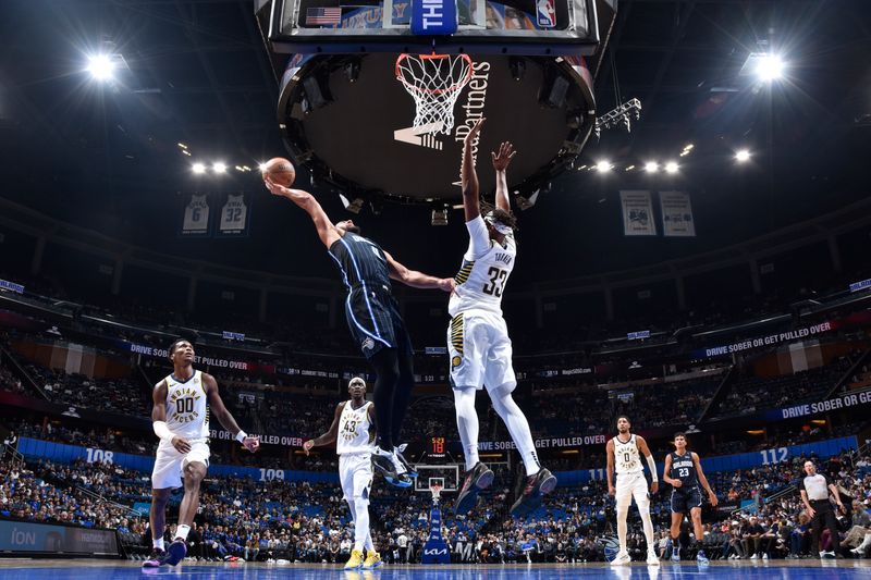 ORLANDO, FL - NOVEMBER 13: Jalen Suggs #4 of the Orlando Magic drives to the basket during the game against the Indiana Pacers on November 13, 2024 at Kia Center in Orlando, Florida. NOTE TO USER: User expressly acknowledges and agrees that, by downloading and or using this photograph, User is consenting to the terms and conditions of the Getty Images License Agreement. Mandatory Copyright Notice: Copyright 2024 NBAE (Photo by Fernando Medina/NBAE via Getty Images)