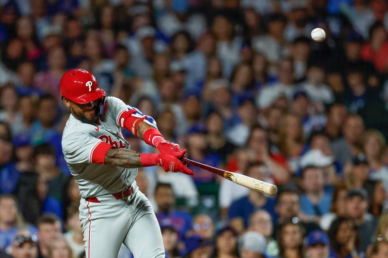 Jul 3, 2024; Chicago, Illinois, USA; Philadelphia Phillies shortstop Edmundo Sosa (33) hits an RBI-sacrifice fly against the Chicago Cubs during the eight inning at Wrigley Field. Mandatory Credit: Kamil Krzaczynski-USA TODAY Sports