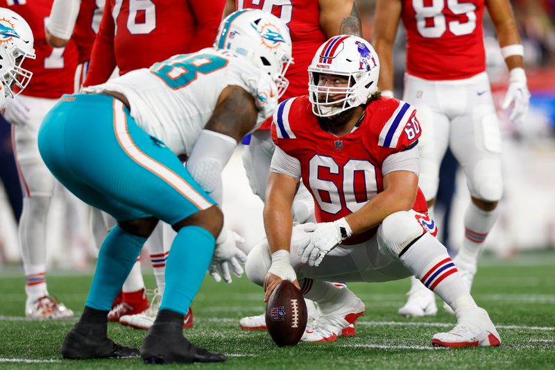 New England Patriots center David Andrews (60) looks to the scoreboard during the second half of an NFL football game against the Miami Dolphins on Sunday, Sept. 17, 2023, in Foxborough, Mass. (AP Photo/Greg M. Cooper)