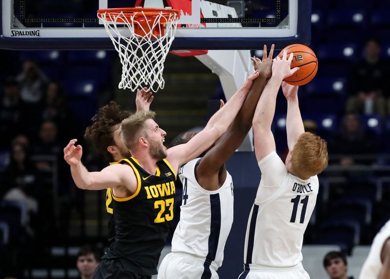 Feb 8, 2024; University Park, Pennsylvania, USA; Iowa Hawkeyes forward Ben Krikke (23) slaps the wrist of Penn State Nittany Lions forward Demetrius Lilley (14) as he and Penn State Nittany Lions forward Leo O'Boyle (11) jump for the rebound during the first half at Bryce Jordan Center. Penn State defeated Iowa 89-79. Mandatory Credit: Matthew O'Haren-USA TODAY Sports