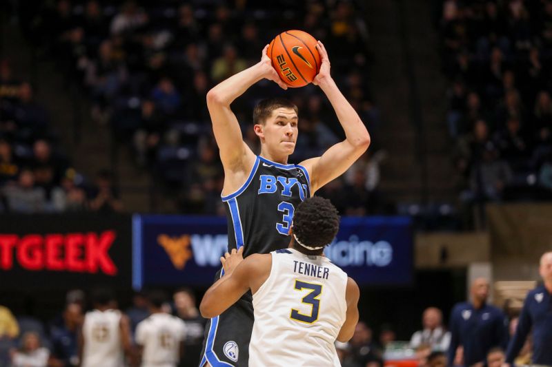 Feb 11, 2025; Morgantown, West Virginia, USA; Brigham Young Cougars guard Egor Demin (3) looks to pass while defended by West Virginia Mountaineers guard KJ Tenner (3) during the second half at WVU Coliseum. Mandatory Credit: Ben Queen-Imagn Images