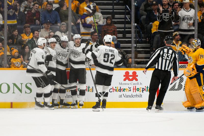 Nov 4, 2024; Nashville, Tennessee, USA;  Los Angeles Kings center Anze Kopitar (11) celebrates his goal with his teammates against the Nashville Predators during the first period at Bridgestone Arena. Mandatory Credit: Steve Roberts-Imagn Images