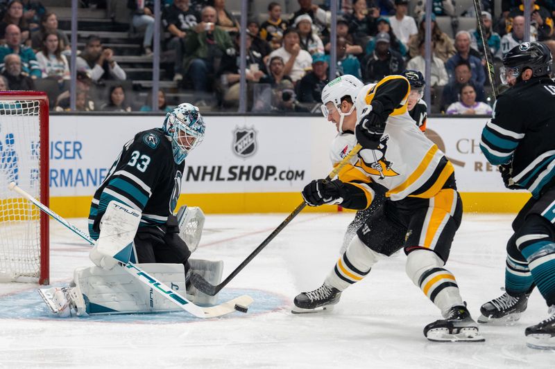 Oct 18, 2025; San Jose, California, USA; San Jose Sharks goaltender Alex Nedeljkovic (33) makes a save against Pittsburgh Penguins center Noel Acciari (55) during first perioid at SAP Center at San Jose. Mandatory Credit: Neville E. Guard-Imagn Images