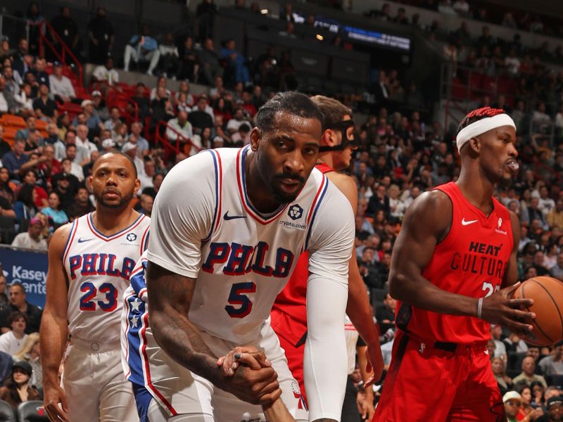 MIAMI, FL - NOVEMBER 18: Andre Drummond #5 helps teammate Jared McCain #20 of the Philadelphia 76ers off the floor during the game against the Miami Heat on November 18, 2024 at Kaseya Center in Miami, Florida. NOTE TO USER: User expressly acknowledges and agrees that, by downloading and or using this Photograph, user is consenting to the terms and conditions of the Getty Images License Agreement. Mandatory Copyright Notice: Copyright 2024 NBAE (Photo by Issac Baldizon/NBAE via Getty Images)