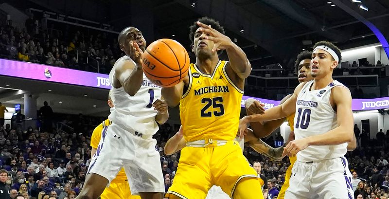 Feb 2, 2023; Evanston, Illinois, USA; Northwestern Wildcats guard Chase Audige (1) defends Michigan Wolverines guard Jace Howard (25) during the first half at Welsh-Ryan Arena. Mandatory Credit: David Banks-USA TODAY Sports