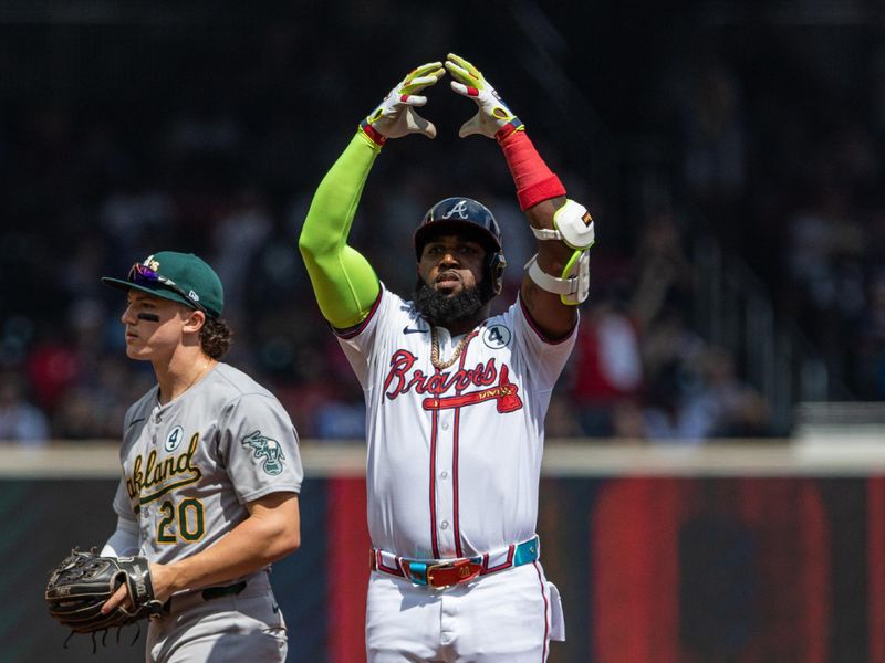 Jun 2, 2024; Cumberland, Georgia, USA; Atlanta Braves designated hitter Marcell Ozuna (20) celebrates hitting a double against the Oakland Athletics during the eighth inning at Truist Park. Mandatory Credit: Jordan Godfree-USA TODAY Sports