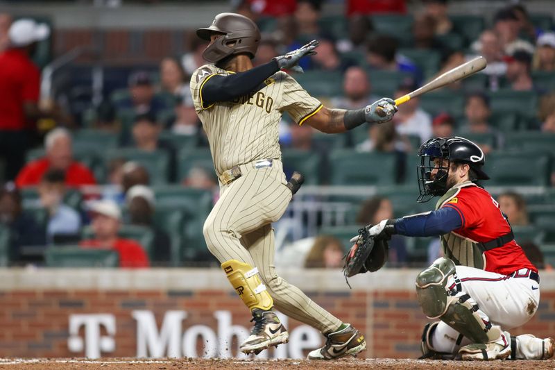 May 17, 2024; Atlanta, Georgia, USA; San Diego Padres left fielder Jurickson Profar (10) hits a RBI single against the Atlanta Braves in the fifth inning at Truist Park. Mandatory Credit: Brett Davis-USA TODAY Sports