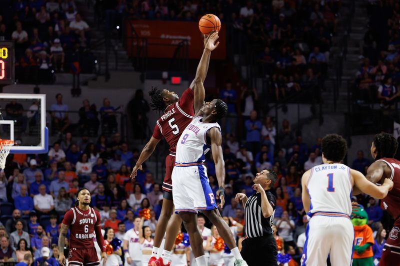 Feb 15, 2025; Gainesville, Florida, USA; South Carolina Gamecocks forward Nick Pringle (5) and Florida Gators center Rueben Chinyelu (9) jump for the ball during the first half at Exactech Arena at the Stephen C. O'Connell Center. Mandatory Credit: Matt Pendleton-Imagn Images