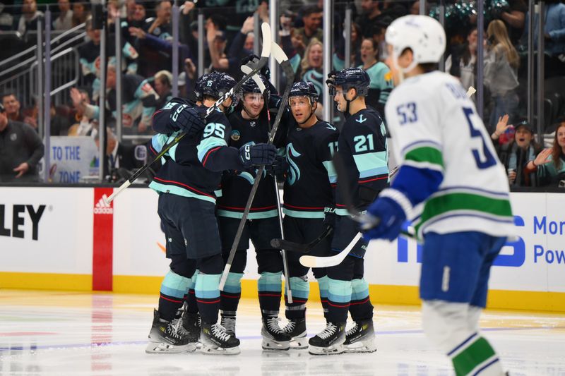 Feb 22, 2024; Seattle, Washington, USA; The Seattle Kraken celebrate after a goal scored by left wing Jared McCann (19) during the second period against the Vancouver Canucks at Climate Pledge Arena. Mandatory Credit: Steven Bisig-USA TODAY Sports