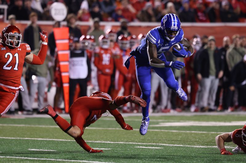 Nov 9, 2024; Salt Lake City, Utah, USA; Utah Utes cornerback Smith Snowden (2) trips up Brigham Young Cougars wide receiver Darius Lassiter (5) during the first quarter at Rice-Eccles Stadium. Mandatory Credit: Rob Gray-Imagn Images