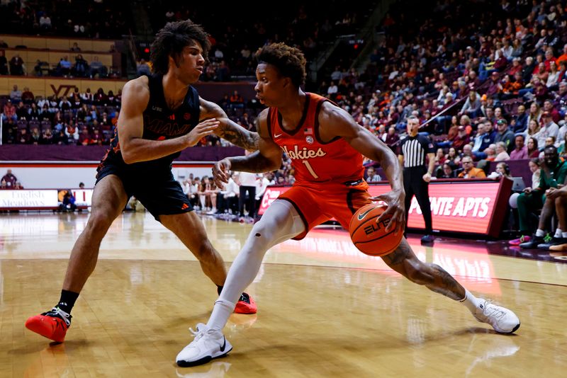 Jan 4, 2025; Blacksburg, Virginia, USA; Virginia Tech Hokies forward Tobi Lawal (1) drives to the basket against Miami Hurricanes forward Isaiah Johnson-Arigu (4) during the first half at Cassell Coliseum. Mandatory Credit: Peter Casey-Imagn Images