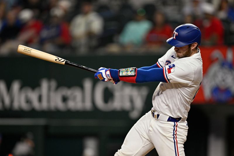 Sep 17, 2024; Arlington, Texas, USA; Texas Rangers catcher Jonah Heim (28) hits a single and drives in two runs against the Toronto Blue Jays during the sixth inning at Globe Life Field. Mandatory Credit: Jerome Miron-Imagn Images