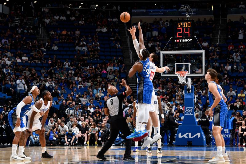 ORLANDO, FL - MARCH 29: Ivica Zubac #40 of the LA Clippers and Wendell Carter Jr. #34 of the Orlando Magic go up for a jump ball on March 29, 2024 at the Kia Center in Orlando, Florida. NOTE TO USER: User expressly acknowledges and agrees that, by downloading and or using this photograph, User is consenting to the terms and conditions of the Getty Images License Agreement. Mandatory Copyright Notice: Copyright 2024 NBAE (Photo by Fernando Medina/NBAE via Getty Images)