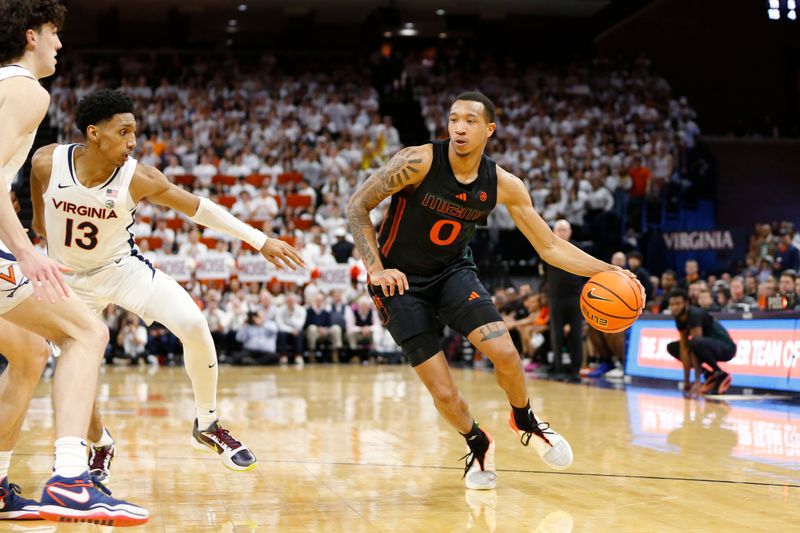 Feb 5, 2024; Charlottesville, Virginia, USA; Miami (Fl) Hurricanes guard Matthew Cleveland (0) controls the ball as Virginia Cavaliers guard Ryan Dunn (13) and Cavaliers forward Blake Buchanan (0) defend during the first half at John Paul Jones Arena. Mandatory Credit: Amber Searls-USA TODAY Sports