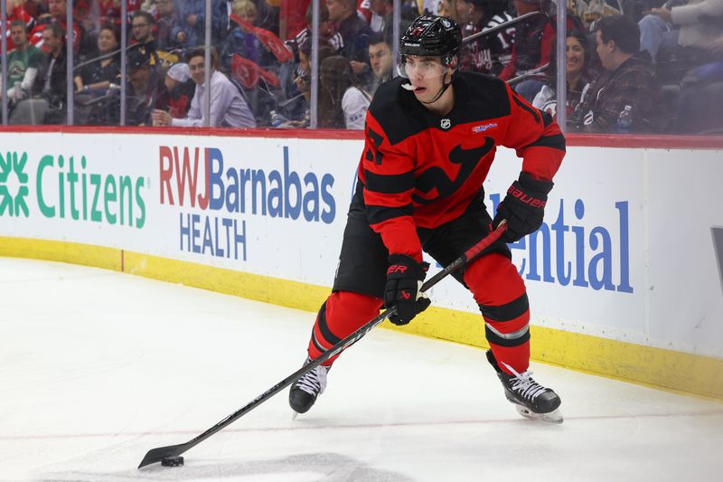 Mar 19, 2024; Newark, New Jersey, USA; New Jersey Devils defenseman Simon Nemec (17) skates with the puck against the Pittsburgh Penguins during the first period at Prudential Center. Mandatory Credit: Ed Mulholland-USA TODAY Sports