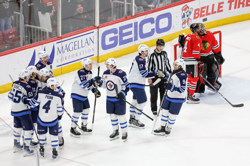 Feb 23, 2024; Chicago, Illinois, USA; Winnipeg Jets left wing Kyle Connor (81) celebrates with teammates after scoring a game winning goal against the Chicago Blackhawks during overtime at United Center. Mandatory Credit: Kamil Krzaczynski-USA TODAY Sports