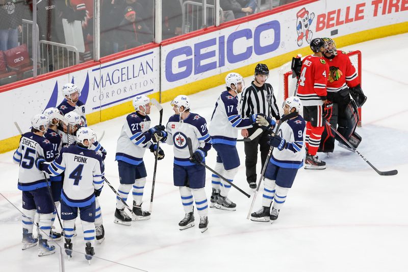 Feb 23, 2024; Chicago, Illinois, USA; Winnipeg Jets left wing Kyle Connor (81) celebrates with teammates after scoring a game winning goal against the Chicago Blackhawks during overtime at United Center. Mandatory Credit: Kamil Krzaczynski-USA TODAY Sports