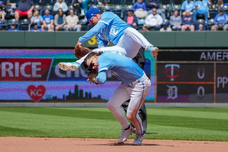 Apr 11, 2024; Kansas City, Missouri, USA; Kansas City Royals second base Nick Loftin (12) dives over shortstop Bobby Witt Jr. (7) going for a ground ball against the Houston Astros in the fourth inning at Kauffman Stadium. Mandatory Credit: Denny Medley-USA TODAY Sports