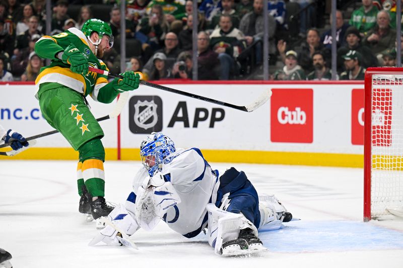 Mar 3, 2026; Saint Paul, Minnesota, USA;  Minnesota Wild forward Yakov Trenin (13) scores against Tampa Bay Lightning goalie Andrei Vasilevskiy (88) during the second period at Grand Casino Arena. Mandatory Credit: Nick Wosika-Imagn Images