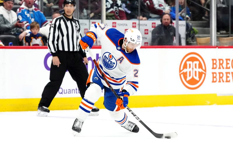 Apr 18, 2024; Denver, Colorado, USA; Edmonton Oilers defenseman Brett Kulak (27) shoots the puck in the third period against the Colorado Avalanche at Ball Arena. Mandatory Credit: Ron Chenoy-USA TODAY Sports