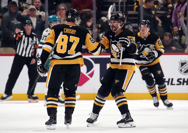 Nov 16, 2024; Pittsburgh, Pennsylvania, USA;  Pittsburgh Penguins defenseman Erik Karlsson (65) congratulates center Sidney Crosby (87) on his goal against the San Jose Sharks during the second period at PPG Paints Arena. Mandatory Credit: Charles LeClaire-Imagn Images