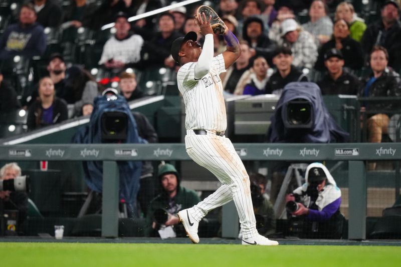 Apr 23, 2024; Denver, Colorado, USA; Colorado Rockies first baseman Elehuris Montero (44) fields the ball in the fifth inning against the San Diego Padres at Coors Field. Mandatory Credit: Ron Chenoy-USA TODAY Sports