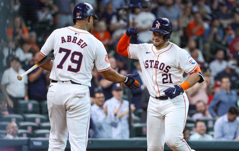 Jun 5, 2024; Houston, Texas, USA; Houston Astros designated hitter Yainer Diaz (21) celebrates with first baseman Jose Abreu (79) after hitting a home run during the fifth inning against the St. Louis Cardinals at Minute Maid Park. Mandatory Credit: Troy Taormina-USA TODAY Sports