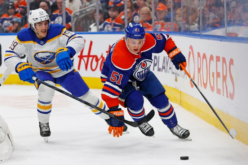 Jan 25, 2025; Edmonton, Alberta, CAN; Edmonton Oilers defensemen Troy Stecher (51) and Buffalo Sabres forward Peyton Krebs (19) chases a loose puck during the second period at Rogers Place. Mandatory Credit: Perry Nelson-Imagn Images