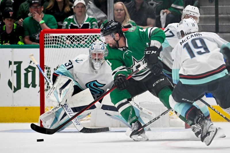 May 15, 2023; Dallas, Texas, USA; Dallas Stars center Luke Glendening (11) attempts to poke a shot past Seattle Kraken goaltender Philipp Grubauer (31) on a short handed attempt in the Seattle zone during the first period in game seven of the second round of the 2023 Stanley Cup Playoffs at the American Airlines Center. Mandatory Credit: Jerome Miron-USA TODAY Sports