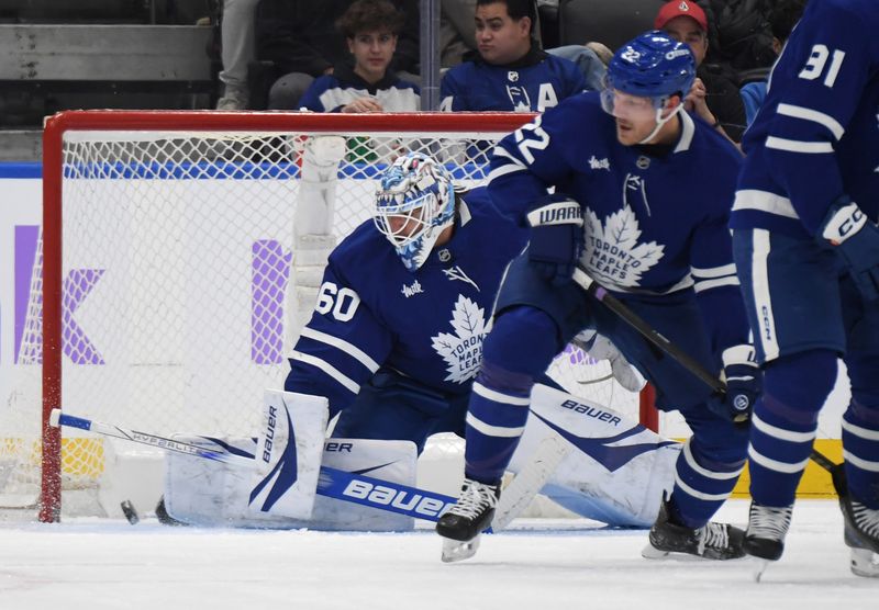 Nov 24, 2024; Toronto, Ontario, CAN;  Toronto Maple Leafs goalie Joseph Woll (60) makes a save against the Utah Hockey Club in the first period at Scotiabank Arena. Mandatory Credit: Dan Hamilton-Imagn Images