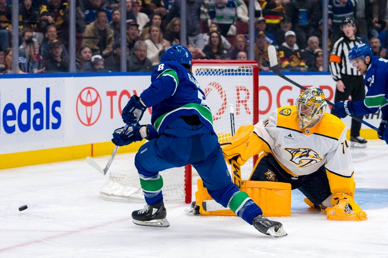 Jan 3, 2025; Vancouver, British Columbia, CAN; Nashville Predators goalie Juuse Saros (74) makes a save on Vancouver Canucks forward Conor Garland (8) in the second period at Rogers Arena. Mandatory Credit: Bob Frid-Imagn Images