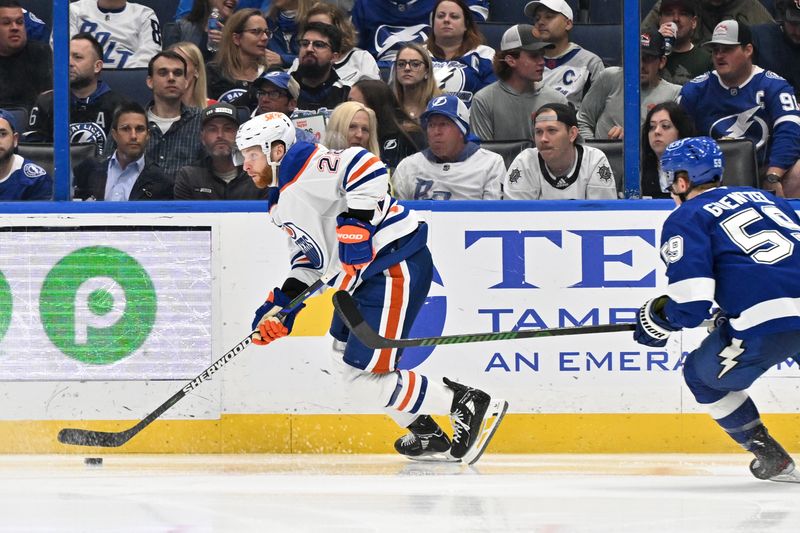 Feb 25, 2025; Tampa, Florida, USA; Edmonton Oilers right wing Connor Brown (28) pushes the puck up the ice in the second period against the Tampa Bay Lightning  at Amalie Arena. Mandatory Credit: Jonathan Dyer-Imagn Images