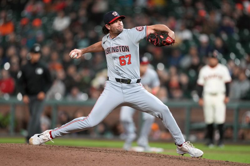 Apr 9, 2024; San Francisco, California, USA; Washington Nationals pitcher Kyle Finnegan (67) throws a pitch against the San Francisco Giants during the eighth inning at Oracle Park. Mandatory Credit: Darren Yamashita-USA TODAY Sports