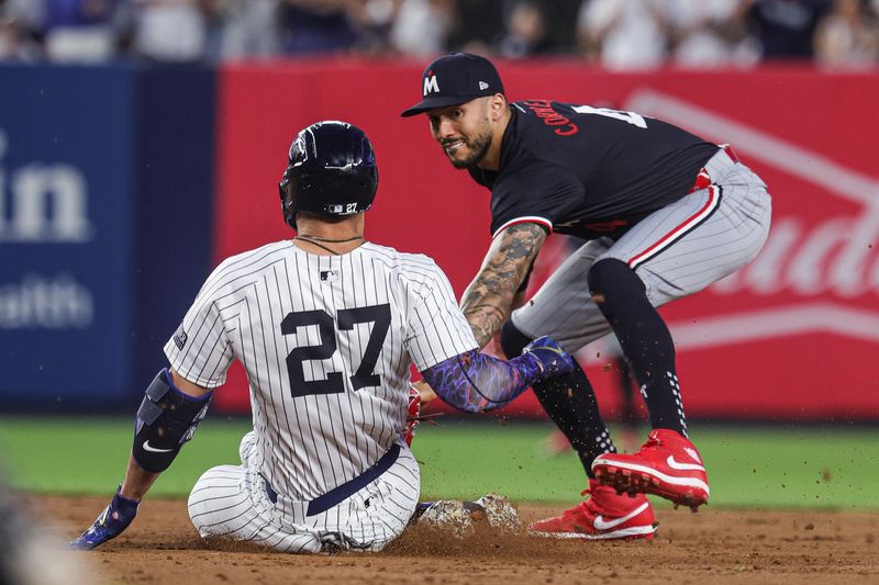 Jun 5, 2024; Bronx, New York, USA; New York Yankees designated hitter Giancarlo Stanton (27) is tagged out by Minnesota Twins shortstop Carlos Correa (4) at second base during the fifth inning at Yankee Stadium. Mandatory Credit: Vincent Carchietta-USA TODAY Sports