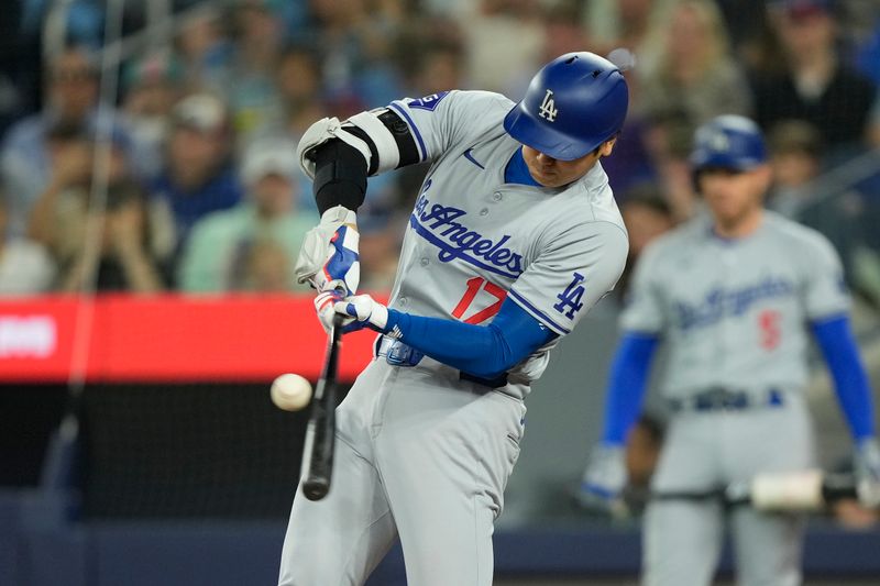 Apr 28, 2024; Toronto, Ontario, CAN; Los Angeles Dodgers designated hitter Shohei Ohtani (17) makes contact with the ball during an at bat against the Toronto Blue Jays during the fourth inning at Rogers Centre. Mandatory Credit: John E. Sokolowski-USA TODAY Sports