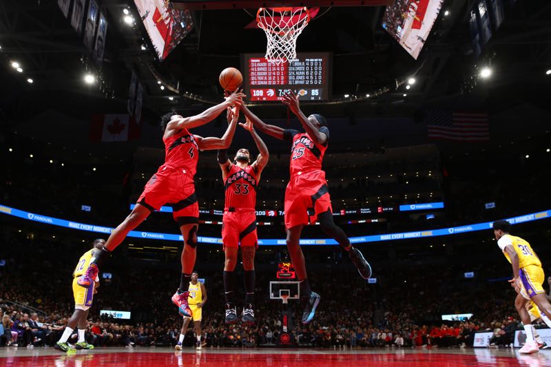 TORONTO, CANADA - DECEMBER 7: Scottie Barnes #4, Gary Trent Jr. #33 and Chris Boucher #25 of the Toronto Raptors attempt to rebound the ball against the Los Angeles Lakers on December 7, 2022 at the Scotiabank Arena in Toronto, Ontario, Canada.  NOTE TO USER: User expressly acknowledges and agrees that, by downloading and or using this Photograph, user is consenting to the terms and conditions of the Getty Images License Agreement.  Mandatory Copyright Notice: Copyright 2022 NBAE (Photo by Vaughn Ridley/NBAE via Getty Images)