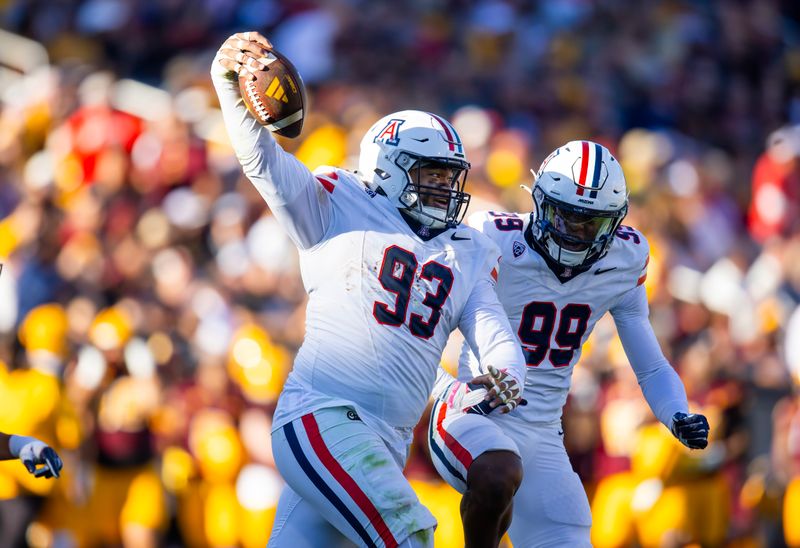 Nov 25, 2023; Tempe, Arizona, USA; Arizona Wildcats defensive lineman Jacob Kongaika (93) celebrates a fumble recovery with teammate Russell Davis II (99) against the Arizona State Sun Devils in the first half of the Territorial Cup at Mountain America Stadium. Mandatory Credit: Mark J. Rebilas-USA TODAY Sports