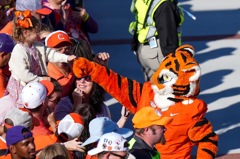 Sep 23, 2023; Clemson, South Carolina, USA; Clemson Tigers mascot The Tiger greets a fan prior to a game against the Florida State Seminoles at Memorial Stadium. Mandatory Credit: David Yeazell-USA TODAY Sports