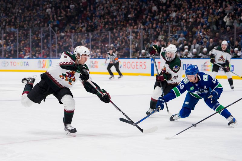 Jan 18, 2024; Vancouver, British Columbia, CAN; Arizona Coyotes forward Matias Maccelli (63) watches as forward Clayton Keller (9) shoots past Vancouver Canucks forward Elias Pettersson (40) in the first period at Rogers Arena. Mandatory Credit: Bob Frid-USA TODAY Sports