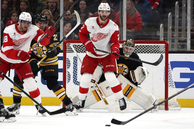 Nov 29, 2025; Boston, Massachusetts, USA; Boston Bruins goaltender Jeremy Swayman (1) keeps his eye on the puck while being screened by Detroit Red Wings center Michael Rasmussen (27) during the first period at TD Garden. Mandatory Credit: Winslow Townson-Imagn Images