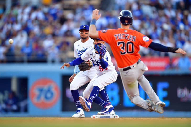 Jun 24, 2023; Los Angeles, California, USA; Houston Astros right fielder Kyle Tucker (30) is out at second as Los Angeles Dodgers second baseman Mookie Betts (50) throws to first for the out against first baseman Jose Abreu (79) during the ninth inning at Dodger Stadium. Mandatory Credit: Gary A. Vasquez-USA TODAY Sports