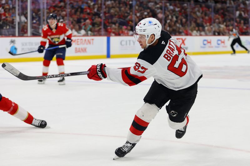 Nov 12, 2024; Sunrise, Florida, USA; New Jersey Devils left wing Jesper Bratt (63) shoots the puck against the Florida Panthers during the first period at Amerant Bank Arena. Mandatory Credit: Sam Navarro-Imagn Images